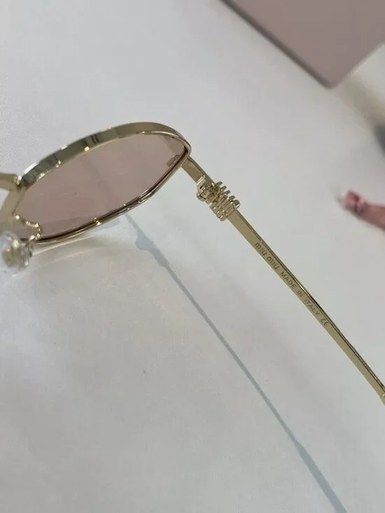 Miu Miu Cat-Eye Sunglasses with Gold Frames and Pink Lenses - Picture 3 of 7